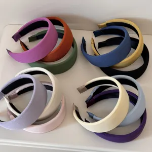 Multiple colorful wide sponge headbands with elegant ribbed fabric texture detail
