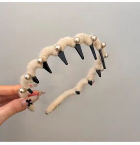 Close-up view of beige knitted wavy headband with elegant pearls and anti-slip teeth
