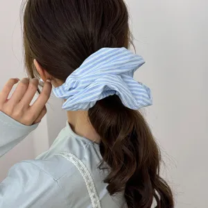 Elegant light blue striped oversized hair scrunchie for a stylish ponytail hairstyle