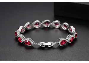 Vista detallada de las piedras rojas en forma de pera y circonitas del brazalete de plata