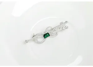 Exquisite detail of retro guitar brooch with silver plating and emerald green stone