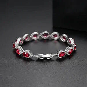 Elegante pulsera de plata con circonitas rojo rubí en forma de pera y cristales.