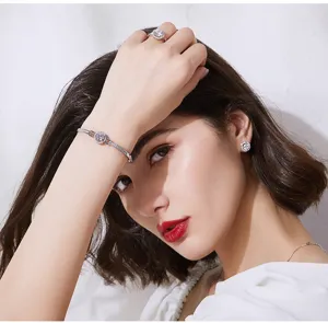 Elegant female model showcasing a sparkling halo ring and matching jewelry set close-up