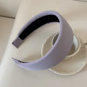 Close-up detail of a lavender ribbed sponge headband with elegant texture on a white cup