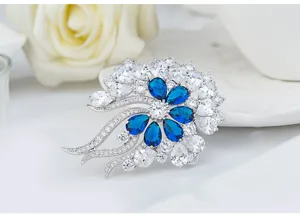 Close-up of retro floral brooch with blue and clear sparkling 3A zircon stones.