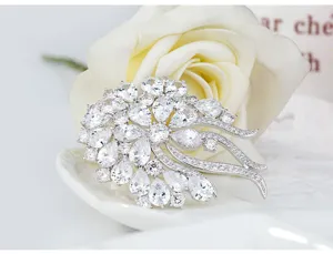 Macro view of elegant floral brooch with pear-shaped cubic zirconia in silver-tone finish.