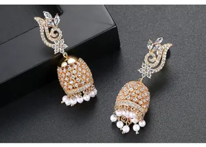Macro view of gold-tone Indian Jhumka earrings with sparkling stones and pearl tassels