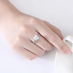 Elegante zilverkleurige ring met sprankelende ronde zirkonia op een handmodel getoond
