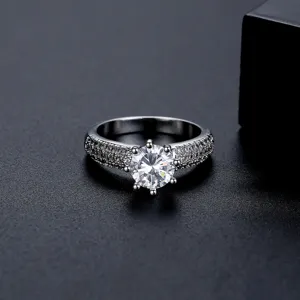 Elegante anillo solitario de seis garras en tono plateado con circonita cúbica redonda.