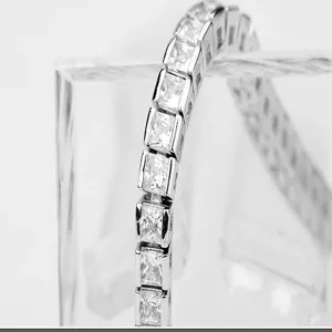 Close-up view of a single row silver tennis bracelet with sparkling square zirconia stones.