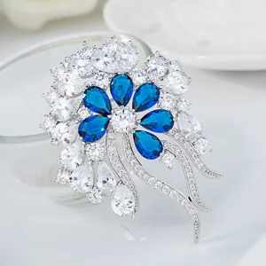 Vintage French floral brooch featuring deep blue and white 3A zircons in a silver setting