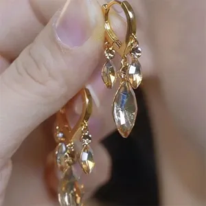 Close-up detail of vintage style brown marquise-cut crystal leaf tassel drop earrings