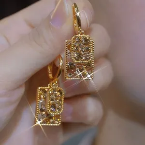 Detailed macro view of sparkling coffee crystals inside vintage golden rectangular earrings