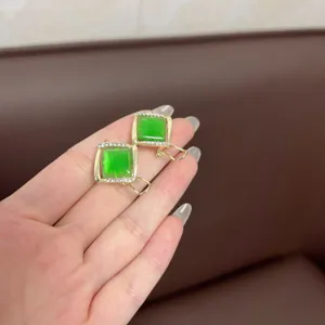 Detail shot of vintage geometric square green stone earrings with shiny rhinestones