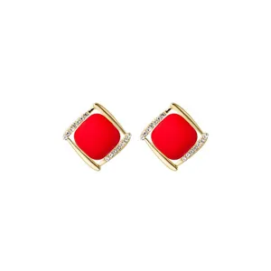 Close-up of Ancora red geometric square stud earrings with sparkling rhinestones