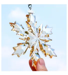Close-up of amber crystal snowflake car ornament with 2023 year tag