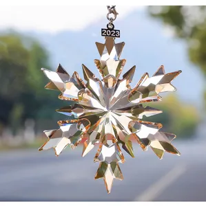 Detailed macro view of a sparkling crystal snowflake car charm with a silver 2023 tag