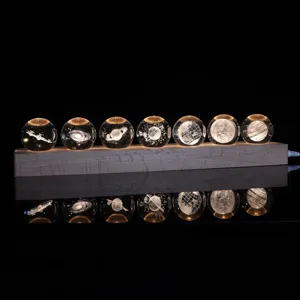 Set of seven 3D laser engraved planetary crystal balls on a warm LED wooden base