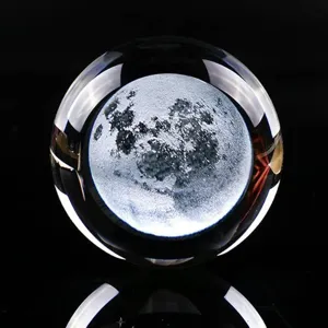 Detailed close-up of a transparent crystal ball with 3D laser engraved moon motif