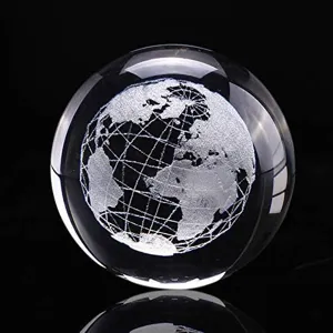 Detailed view of a 3D laser-engraved globe inside a clear crystal ball ornament