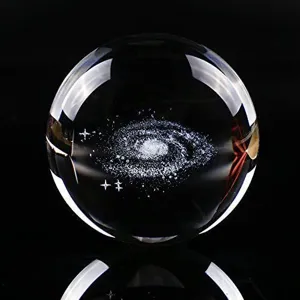 Close-up of clear crystal ball with internal 3D laser-etched galaxy design