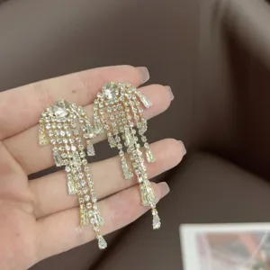 Elegant gold tassel earrings with shimmering clear crystals for evening wear occasions