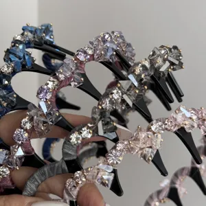 Detail of crystal-encrusted toothed headbands in various colors for elegant hair styling.