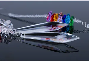 Macro detail of faceted K9 crystal prism pendant with rainbow beads and reflections.