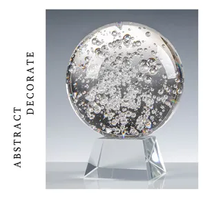 Macro view of a clear K9 crystal sphere with inner bubbles on a glass base stand