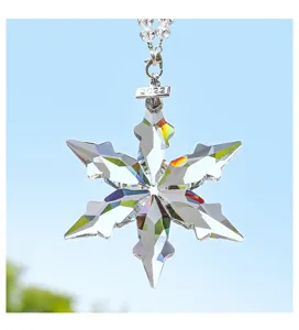 Detailed shot of crystal snowflake car hanging ornament with sparkling multi-faceted design.