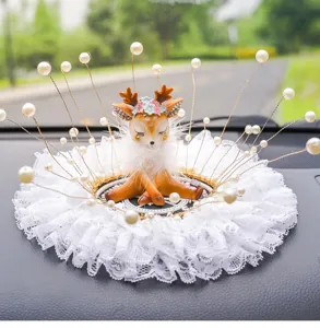 Close-up view of a cute deer car ornament decorated with elegant white lace and pearls