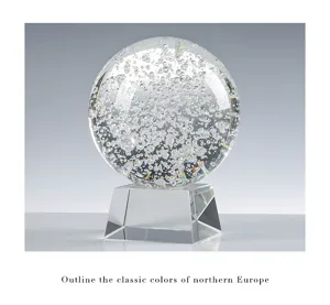 Detailed view of a K9 transparent crystal ball with dense internal bubbles on a glass base