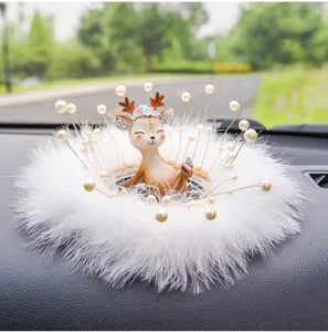 Detailed view of cute cartoon deer car dashboard ornament with white feathers and pearls