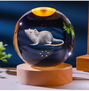 Close-up of 3D laser engraved mouse crystal ball night light on a round wooden base