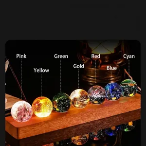Seven colorful luminous glass crystal balls on a wooden stand for luxury home decor