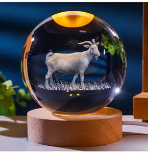 Close-up of 3D laser-engraved goat inside a crystal ball night light with wooden base