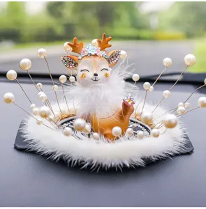 Close-up of creative deer car ornament featuring elegant pearls and soft white fur.
