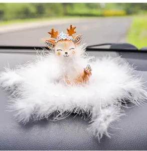Close-up of a cute deer car ornament with flower crown and white feather base