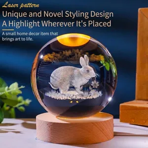 Elegant crystal ball night light with laser-etched rabbit on a glowing wooden base