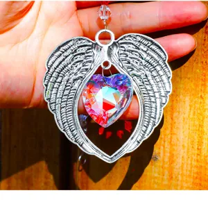 Close-up detail of silver angel wings suncatcher with a faceted rainbow crystal heart.