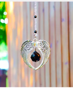 Detailed view of silver angel wing sun catcher ornament featuring a black crystal droplet