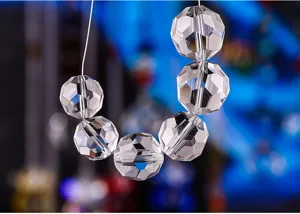 Detailed close-up of clear faceted crystal beads for chandelier decoration and DIY crafts.