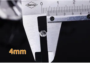 Macro view of 4mm faceted transparent crystal bead being measured by a vernier caliper