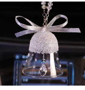 Close-up of sparkling K9 crystal bell car pendant with silver ribbon bow