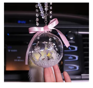 Detail of star crystal ball car pendant with pink bow and beaded chain