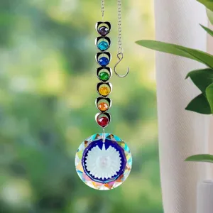 Detail view of the suncatcher featuring a sun-face prism and seven colorful crystals