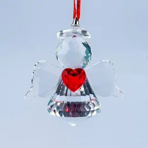 Detailed close-up of a faceted crystal angel suncatcher with a vibrant red heart