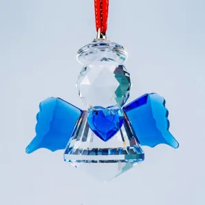 Detailed macro view of a crystal angel suncatcher featuring blue wings and a blue heart