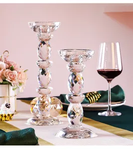 Pair of elegant faceted crystal glass candlesticks arranged on a romantic dining table