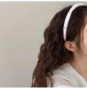 Primer plano de una diadema acolchada rosa con brillantes de mariposa en el cabello